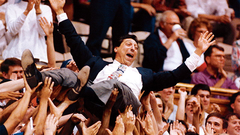 Photo of basketball coach Jim Valvano carried by audience members